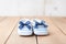 Newborn striped baby shoes on wooden background