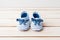 Newborn striped baby shoes on wooden background