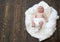 Newborn toddler with blue eyes and curious face on wood