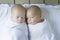 Newborn Twin Babies Swaddled in White