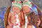 Newborn twin boys sleeping in a basket