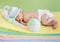 Newborn weared cap sleeping on colourful towels