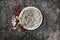 Newborn winter background - round cream bowl with CHristmas red berries and snow covered branches  garland on dark backdrop