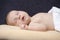 Newborns Concepts. Macro Shoot Of Peacefully Sleeping Gentle Newborn Baby With Dummy On Pale Yellow Blanket