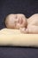 Newborns Concepts. Macro Shoot Of Peacefully Sleeping Gentle Newborn Baby With Dummy On Pale Yellow Blanket