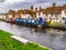 Newbury, Berkshire, UK November 19 2023. Kennet and Avon canal and towpath. Blue narrowboat and Tudor housing.
