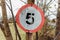 Newcastle UK:A damaged 5mph speed limit sign on a country road in England