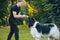 Newfoundland dog plays with man and woman