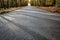 Newly asphalted rural road seen empty.