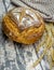 Newly baked sourdough bread on a baking wire with a cloth.