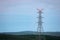 Newly built electricty pylon in the forest. Electric grid background.