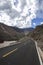 A newly built flat asphalt road leads to the foot of the mountain