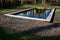 Newly built rectangular swimming pool for fish farming. the pool has an air supply for oxygenation. the edge of the pond is lined