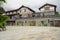 Newly built tile-roofed building with terrace in cloudy afternoon