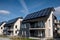 Newly constructed homes with solar panels on the roof.