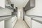 Newly fitted kitchen with white and gray cabinets, white porcelain