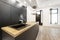 Newly installed open plan kitchen with black cabinets, appliances and faucets and an island with a wood countertop on laminate