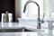 newly installed sleek, shiny kitchen faucet on a sink