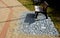 Newly introduced park beige gravel walkways, metal rusty corten steel design strips in the road surface. benches on a square stone