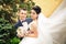 Newly married couple kissing.wind lifting long white bridal veil.