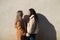 Newly married lesbian couple on a honeymoon in a city. The women are looking at each other`s faces in love and showing their love