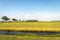 Newly mowed grassland in the foreground with a modern farm with