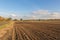 Newly ploughed field in the Essex countryside on a bright day.