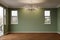 Newly Remodeled Room of House with Wood Floors, Moulding, Olive Green Paint and Ceiling Lights