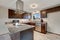 Newly renovated kitchen with dark wood cabinets and granite counter tops