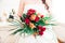 Newly Wed Woman Holding her Red, Orange and Green Bridal Bouquet