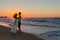 Newly wed young couple on a hazy beach at dusk