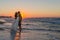 Newly wed young couple on a hazy beach at dusk