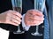 Newly weds hands with wedding rings and champagne