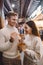 Newlywed couple eating noodles with chopsticks in Shanghai outside a food market