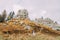 Newlywed couple kissing on majestic outdoor landscape with massive rocks as backround