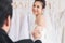 Newlywed cute bride and groom hold hand togher dancing in fitting room