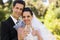 Newlywed toasting champagne flutes at park