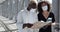 Newlyweds african american couple of people stand together wearing protective medical masks against coronavirus on their