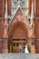 Newlyweds against the background of the neo-Gothic portal of the Catholic Cathedral in Moscow