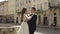 Newlyweds, caucasian groom with bride walking, embracing, hugs on the city street, wedding couple