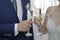 Newlyweds clink glasses with champagne