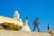 Newlyweds couple on cliffside villa rooftop Santorini island Greece