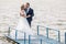 Newlyweds dancing on the bridge at the lake