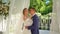 Newlyweds dancing in rotunda with white curtains developing in wind