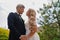 newlyweds. groom and bride in traditional wedding clothes cuddling in park