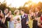 Newlyweds with guest on their garden party