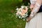 Newlyweds hold the wedding bouquet in their hands