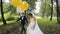 Newlyweds holding balls of white and yellow