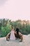 Newlyweds holding hands at the edge of the canyon and couple looking each other with tenderness and love. Outdoors