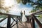 Newlyweds holding hands on the river pier